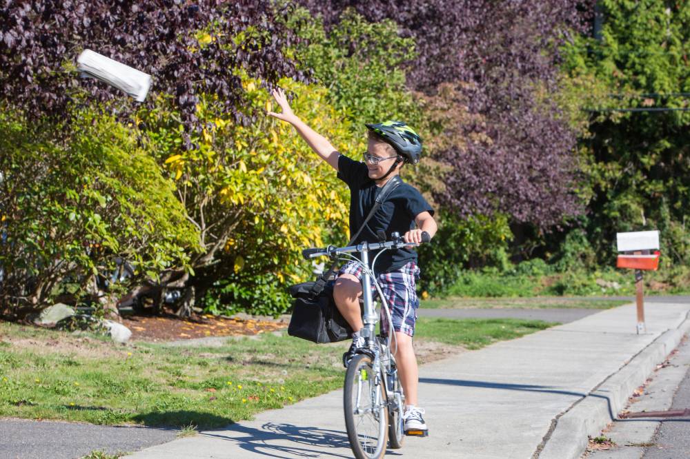 Newspaper delivery boy on his bicycle